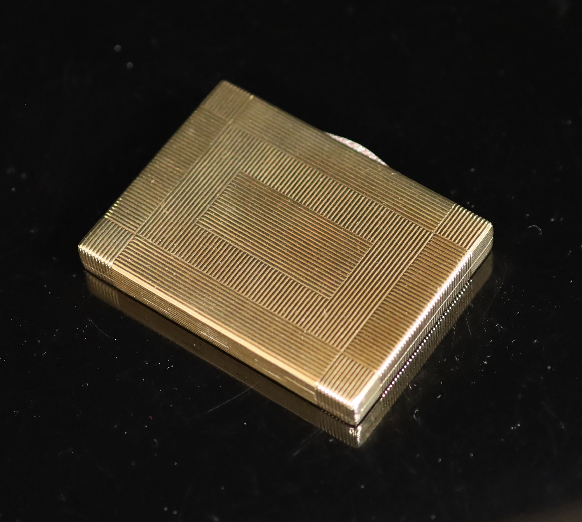 A 1930's Cartier 9ct gold compact, with diamond set thumbpiece